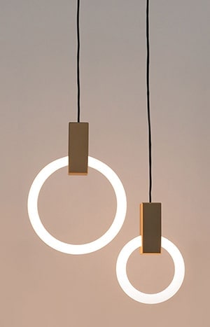 Minimalistische hanglampen met cirkelvormige lichtslierten en goudkleurige details.