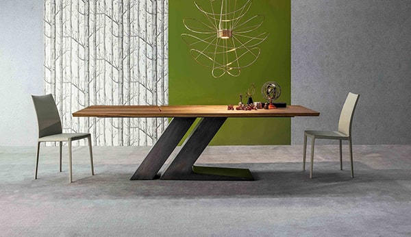 Moderne eettafel met uniek zwart onderstel en houten blad in een stijlvolle kamer.